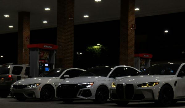 three white cars parked at night
